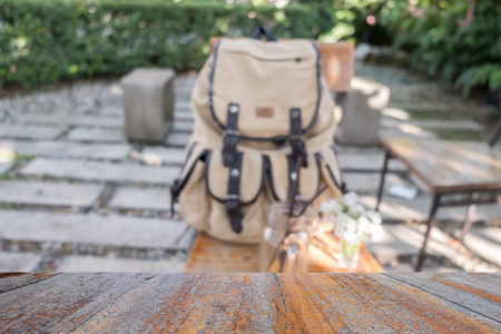 Blurred Backpack on chair with wooden table on frontの写真素材