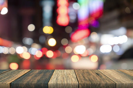 Empty wooden table in front abstract blurred bokeh colorful background, used for mock up and presentationの写真素材