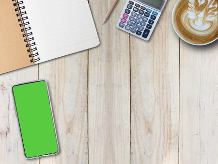 Top view desk background and hot coffee and mobile phone and notepad, copy spaceの写真素材