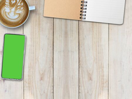 Top view desk background and hot coffee and mobile phone and notepad, copy spaceの写真素材