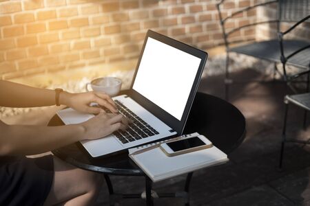 Woman using laptop to working on desk, mock up on screen, freelance and business womanの写真素材