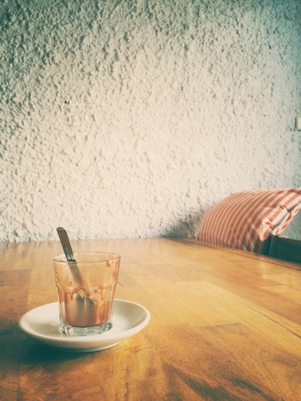 An empty clear cup of cup of icecream on the table at the cafe in retro filter effectの素材