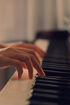 hands playing piano, selective focusの写真素材