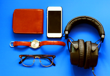 Top view mock up set of everyday life stuff : smart phone, eye glasses,watch, headphone and purse in retro filter effect lightingの写真素材