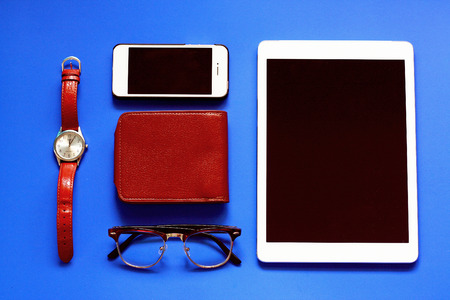 Top view mock up set of everyday life stuff : smart phone,tablet, eye glasses, and purse in retro filter effect lightingの写真素材