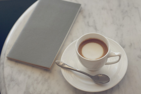 latte or cappuccino or espresso machiato coffee on marble desk in soft tone pastel retro filter effectの写真素材