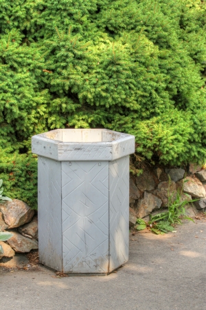 wooden trash can and green tree and stonesの写真素材
