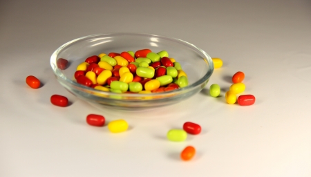 photo of the sweet color candies in small bowlの写真素材