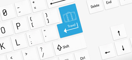 white keyboard with travel key and suitcase