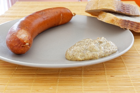 Tasty sausages with two pieces of bread and mustard.の写真素材