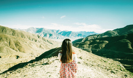 Woman facing the mountains