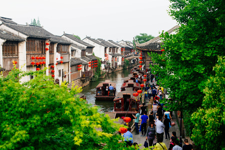 Crowded tourist destination near a canal in an ancient townのeditorial素材