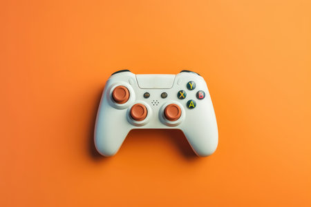 White joystick on orange background. Flat lay, top view, copy spaceの素材