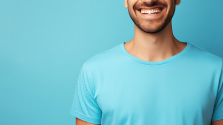 Cropped image of handsome young man in t-shirt on blue backgroundの素材