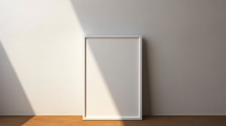 Blank picture frame mockup on a white wall.の素材