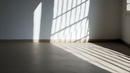Empty room with light from window and shadow on the wall and floorの素材