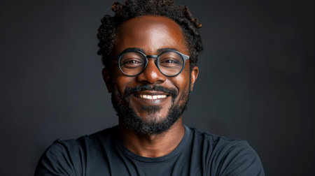 happy african american man in glasses on dark backgroundの素材