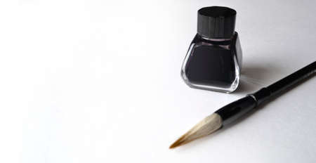 Ink bottle with brush for painting chinese painting on whiteの写真素材