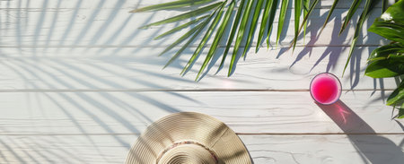Flat Lay of Pink Summer Drink and Straw Hat on White Wooden Table with Palm Leaf Shadows Copy space.の素材