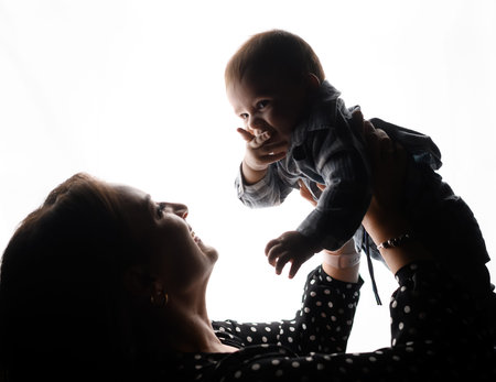 Silhouette of young family mom son