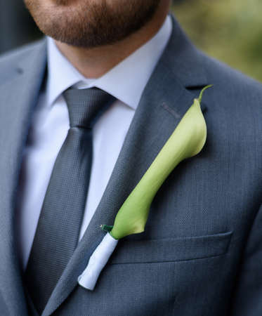 Boutonniere with calla lilies on a bare jacketの写真素材