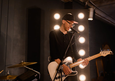 Young Caucasian guitarist plays electric guitarの写真素材