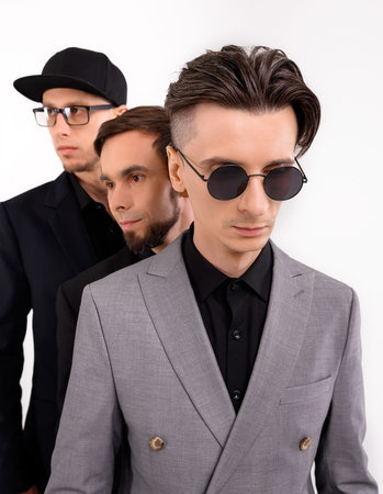 Three caucasian young guys posing stylishly