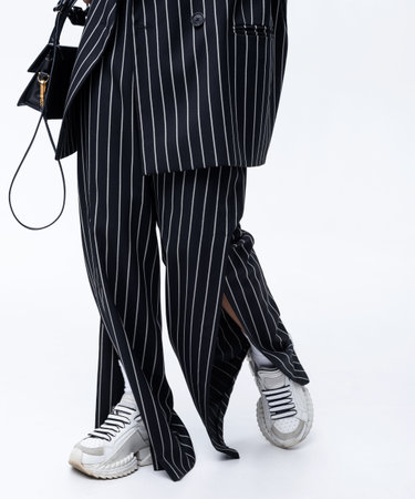 Beautiful Asian brunette girl in a stylish black fashion suit posingの写真素材