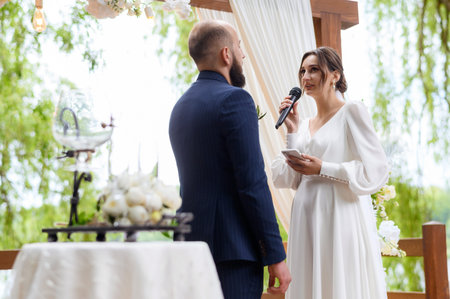 A beautiful couple of newlyweds make marriage promisesの写真素材