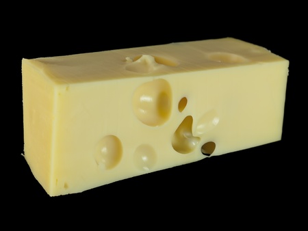 A piece of cheese Isolated on a black backgroundの写真素材