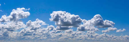 Horizontal landscape with white clouds and blue sky.