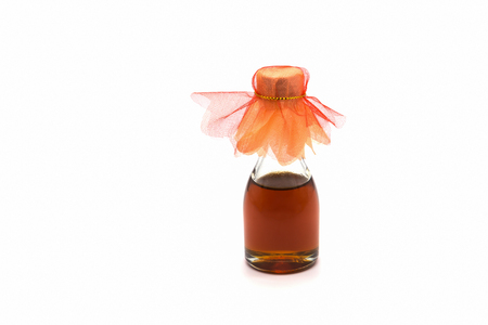 Small bottle of honey isolated on white backgroundの写真素材
