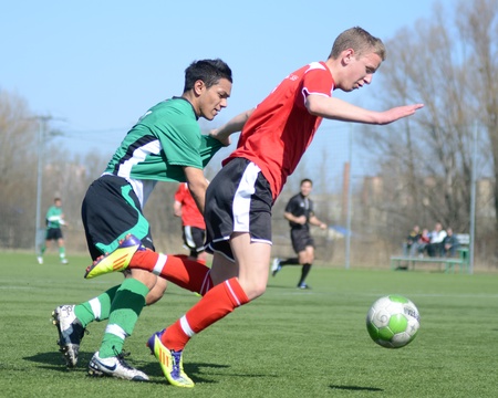 KAPOSVAR, HUNGARY - MARCH 16: Unidentified players in action at the Hungarian National Championship under 17 game between Kaposvar (green) and Szentlorinc (red) on March 16, 2012 in Kaposvar, Hungary.のeditorial素材
