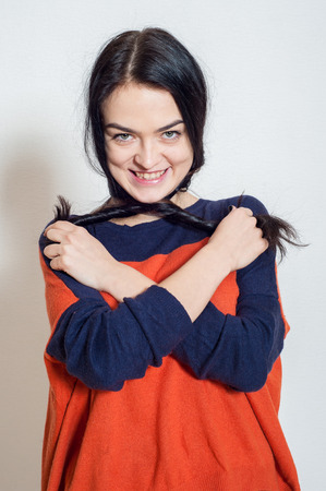 portrait of a beautiful young girl on a light backgroundの写真素材