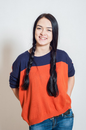 portrait of a beautiful young girl on a light backgroundの写真素材