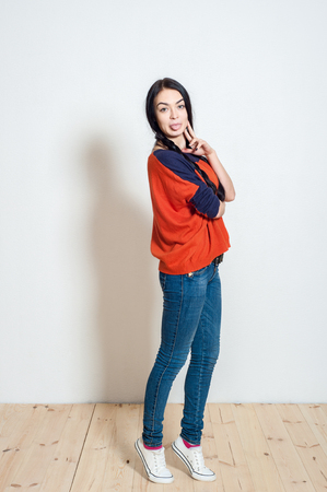 portrait of a beautiful young girl on a light backgroundの写真素材