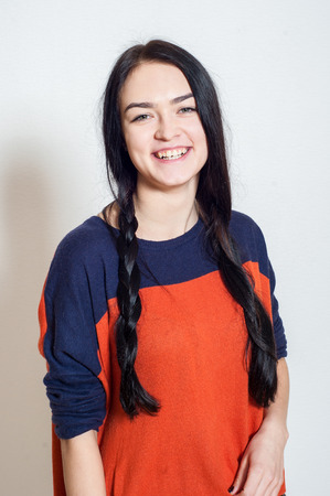 portrait of a beautiful young girl on a light backgroundの写真素材