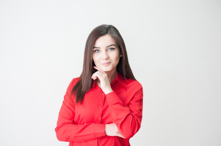 Portrait of a young girl on a white background in a red shirtの写真素材