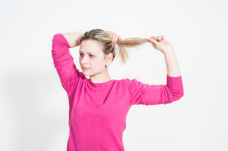 Portrait of a young smiling girl on a white backgroundの写真素材