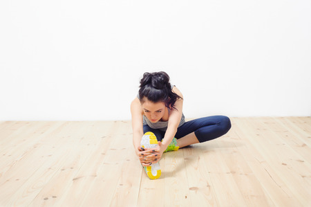 young beautiful girl engaged in fitness at homeの写真素材