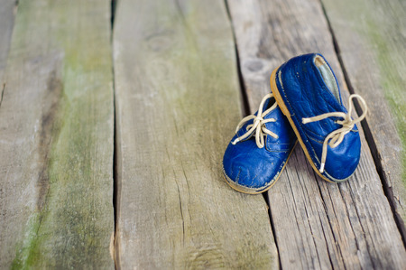 Vintage boot on wood, retro background.の写真素材