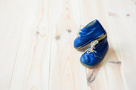 Vintage boot on wood, retro background.の写真素材