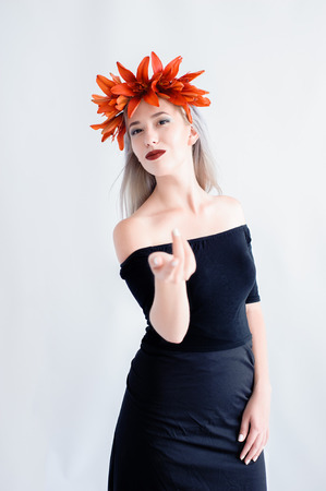 Portrait of a beautiful young girl in a black lenses with liliesの写真素材