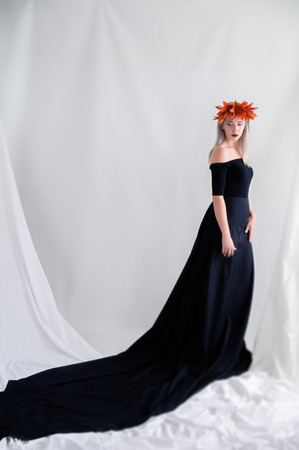 Portrait of a beautiful young girl in a black lenses with liliesの写真素材