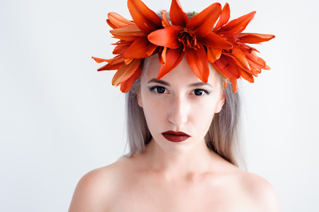 Portrait of a beautiful young girl in a black lenses with liliesの写真素材