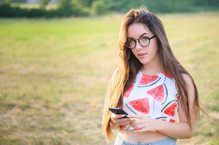 Portrait of a young woman in a park at sunsetの写真素材
