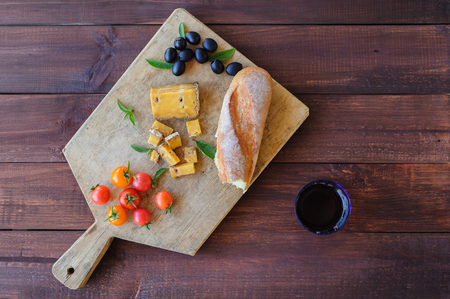 Piece of blue cheese, olives, and tomatoes close upの写真素材