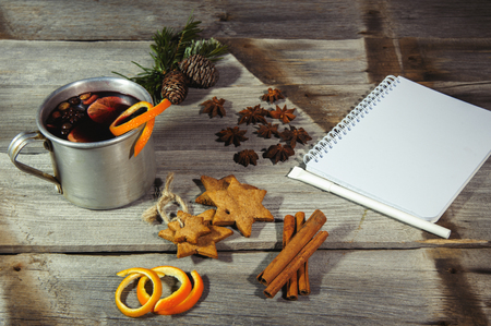 Traditional fruity mulled wine from the old mug, on an old wooden tableの写真素材