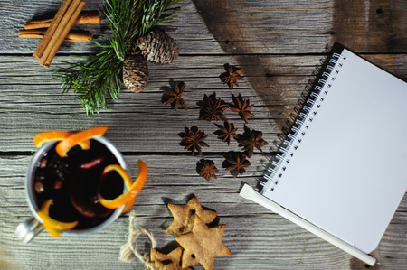 Traditional fruity mulled wine from the old mug, on an old wooden tableの写真素材