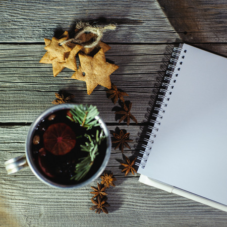 Traditional fruity mulled wine from the old mug, on an old wooden tableの写真素材